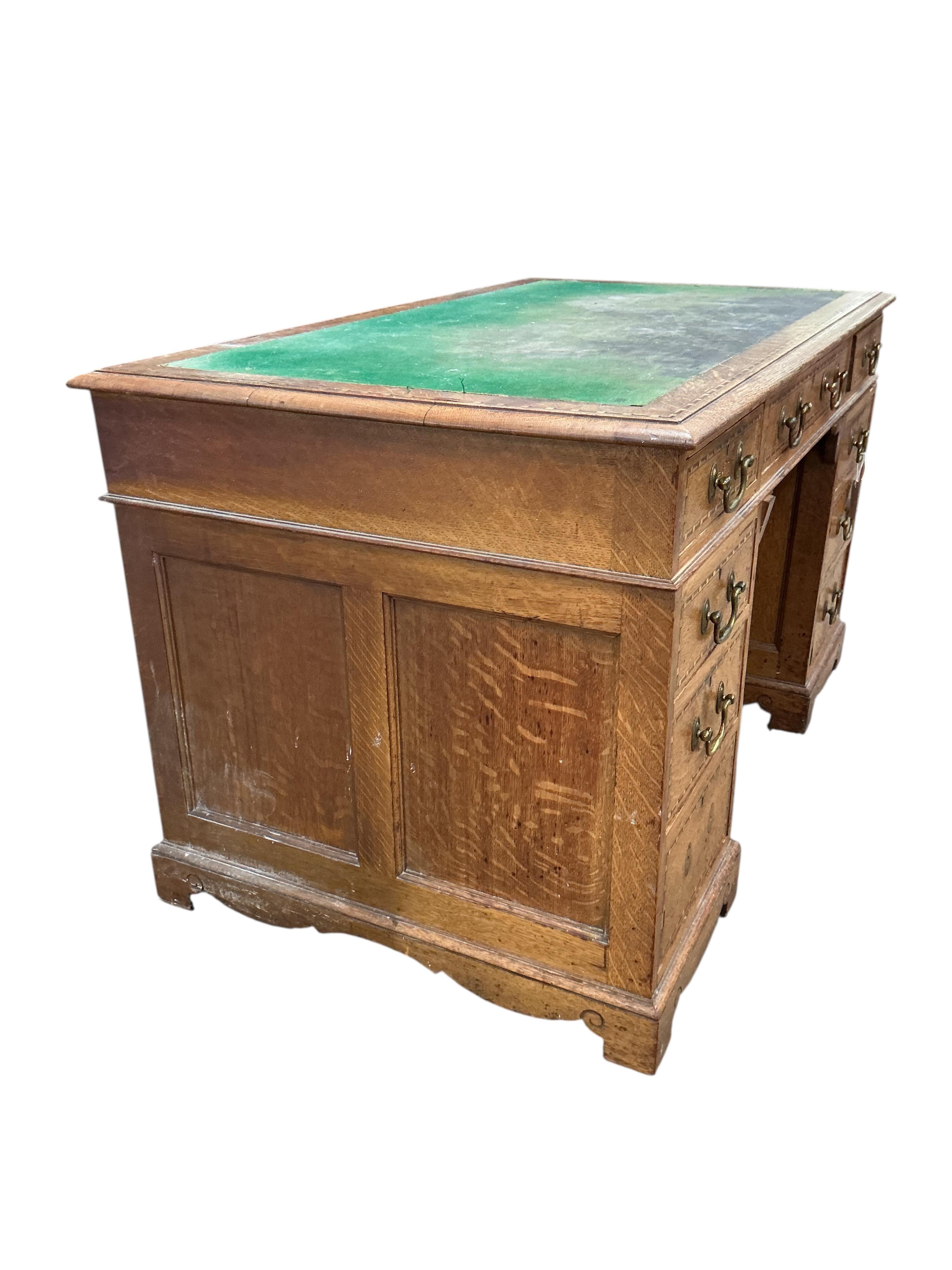 A late Victorian parquetry inlaid oak pedestal desk bears ivorine label Robson & Sons, Newcastle-on-Tyne, width 129cm, depth 76cm, height 76cm